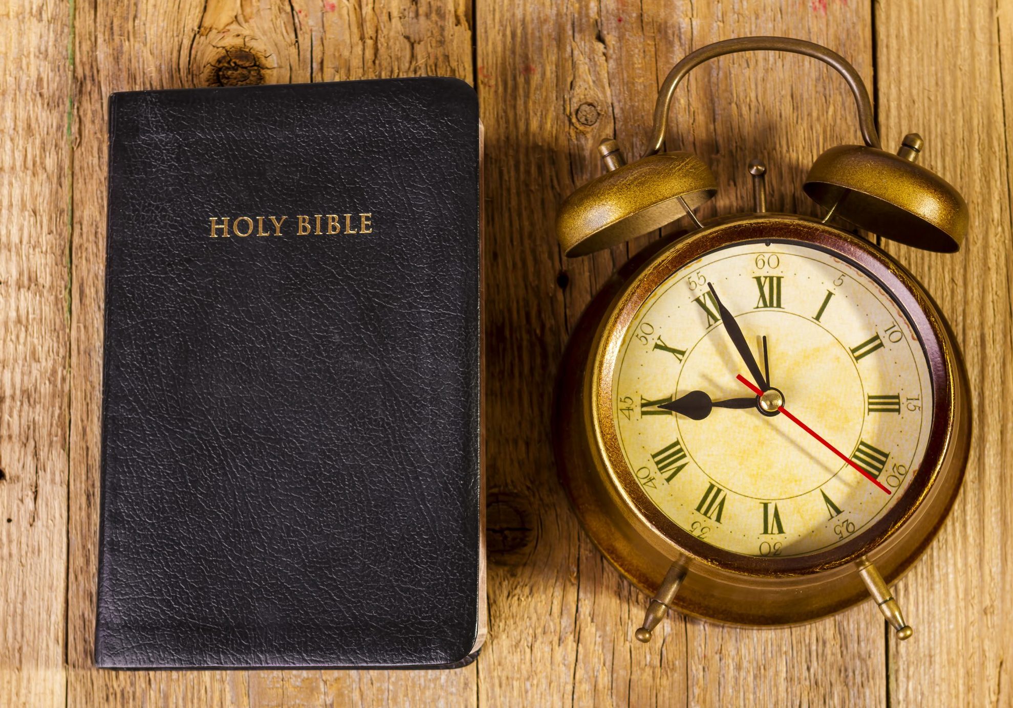 bigstock-Bible-with-Clock-on-Wood-65642572
